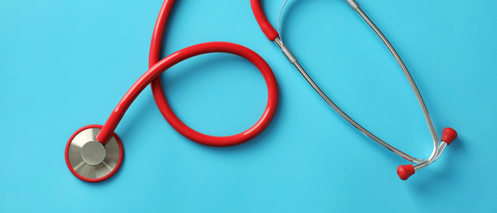 Photo of red stethoscope on blue background